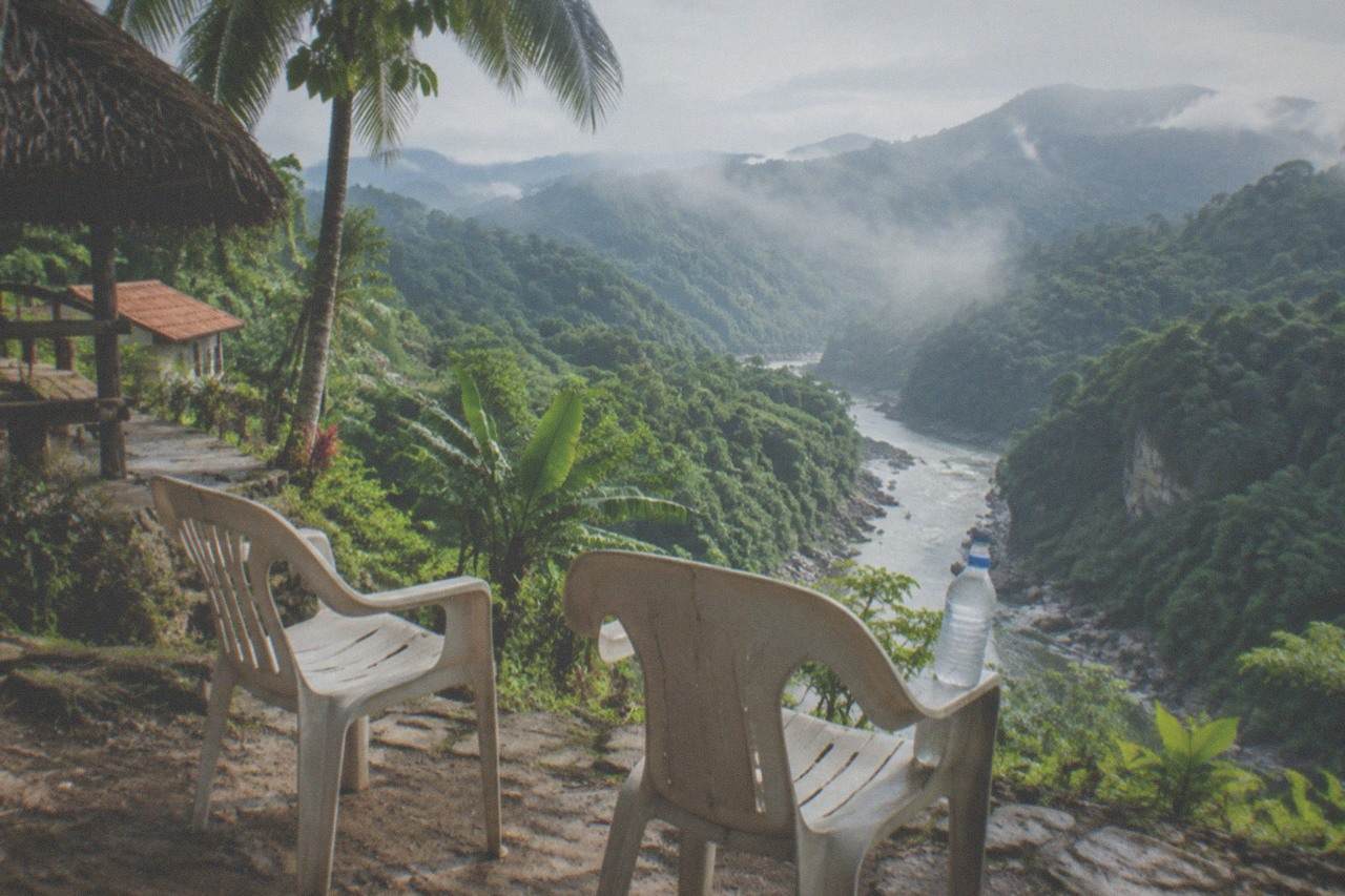 Two chairs on an empty jungle viewpoint above a river canyon near Puerto Vallarta