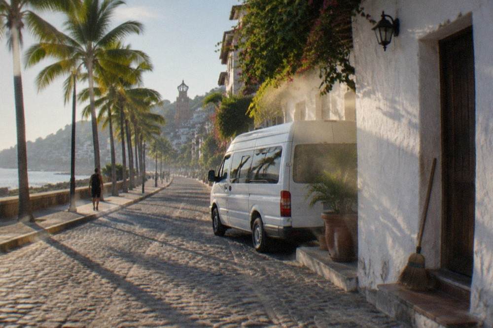 A tour van parked on a Puerto Vallarta street in the early morning light